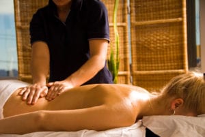 woman receiving massage therapy for muscle pain