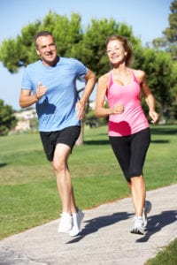 couple exercising the pain away in local park